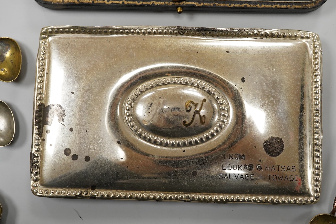 A collection of silver and white metal items, to include a cigarette box, a/f, a German dwarf candlestick, a cased spoon and pusher, etc.